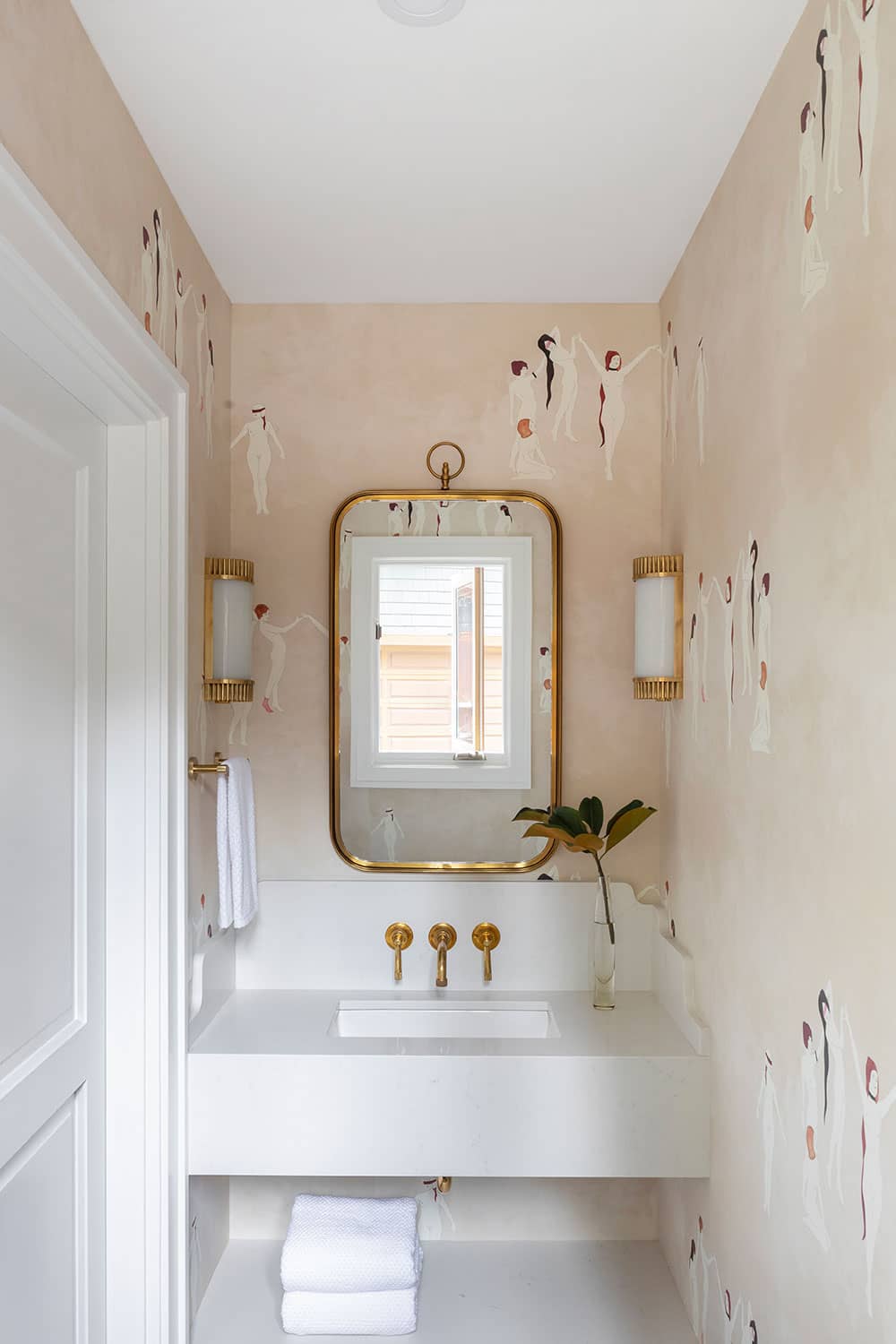 renovated powder room with designer wallpaper, brass fixtures and modern farmhouse sink